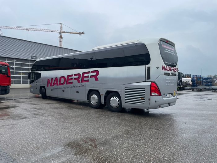 Picture shows Neoplan bus for rent from the back back
